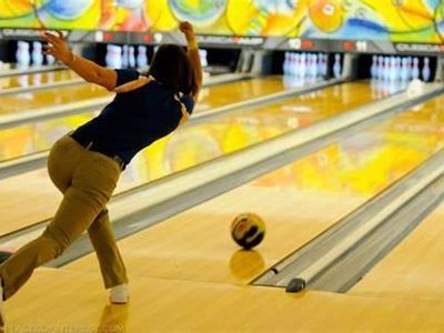 What is it called when a bowler knocks down all ten pins with the first ball?