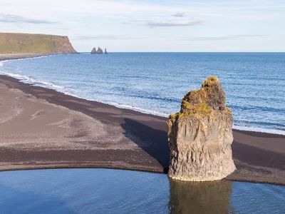 Which landform is a low-lying coastal landform formed by deposition of sediments?