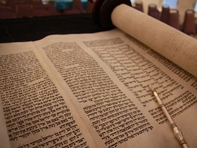 Which sacred text is considered the core of Jewish tradition and contains the Five Books of Moses?