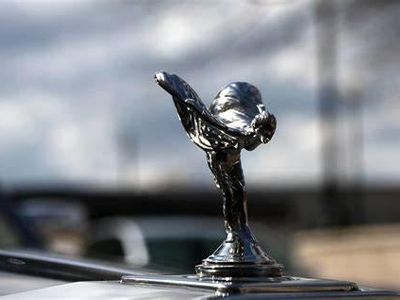 Which luxury car brand is associated with its famous 'Spirit of Ecstasy' hood ornament?