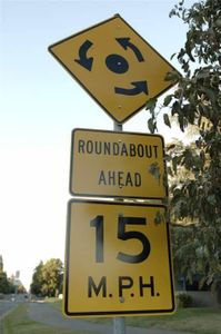 What does a roundabout sign indicate?