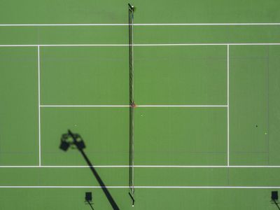 Which line separates the two halves of the tennis court?