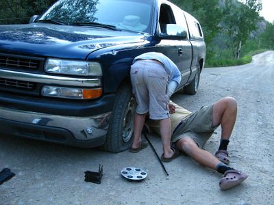 What should you do if you experience a tire blowout while driving on the highway?