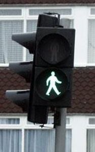 You want to cross the road and ahead of you is a road crossing (Pelican crossing). As you reach it the lights show the green man flashing. Can you..