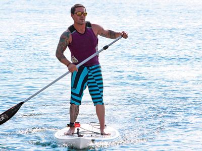 Which activity involves using a paddleboard and a paddle to navigate waterways?