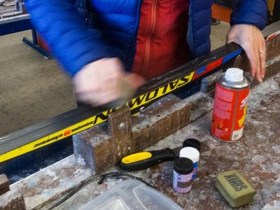 What is the main purpose of waxing skis?