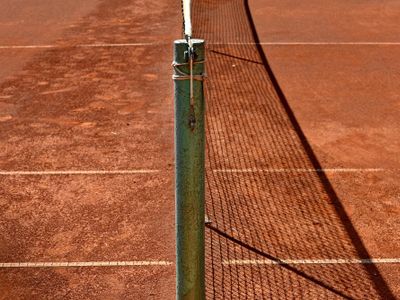 What is a common name for a tennis court divider net?