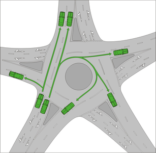 What should you do when taking an exit in a roundabout?