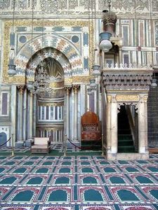 What is the term for the niche in a mosque that indicates the direction of Mecca?