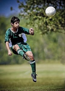 Which position is the only one allowed to kick the ball out of their hands?