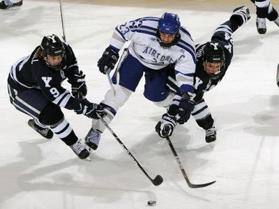 Which game is played on ice with a puck and two teams of six players each?