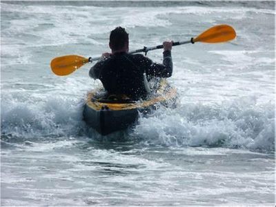 What does the term 'edging' refer to when kayaking?