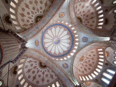 Which famous mosque is known for its stunning blue Iznik tiles?