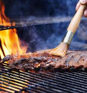 What is the purpose of basting meat while grilling?