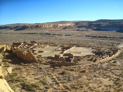 Which landform is a circular depression often surrounded by steep cliffs?