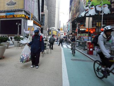 Why is it important to check for cyclists before opening your car door on a street?