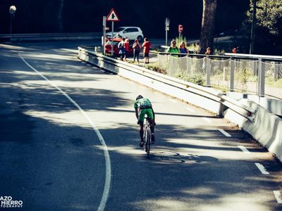 What is the correct technique for climbing uphill while cycling?