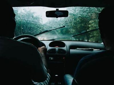 When driving in heavy rain, you should: