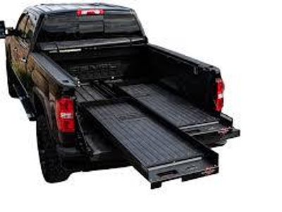 What is a benefit of using a cargo slide in a truck bed?