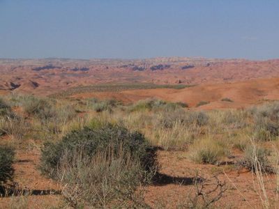 Which landform is a large, flat area elevated above the surrounding landscape?