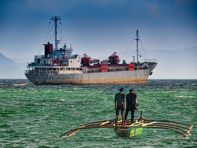 What is the purpose of outriggers on a fishing boat?