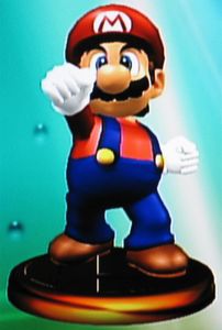 In Super Smash Bros. Melee (Gamecube), which trophy of Mario describes Mario's mass? (Not offensively.)