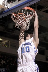 How should your dominant arm move while dunking?