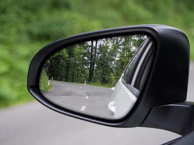 What is the purpose of side view mirrors on a car?