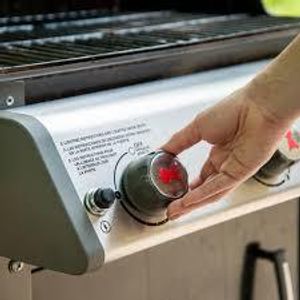 What is the purpose of preheating the grill?