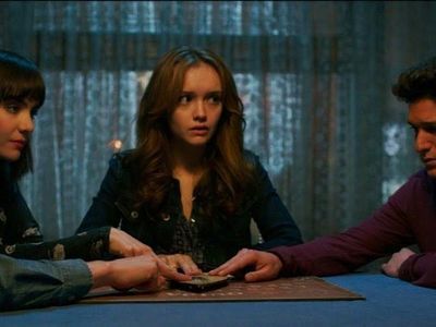 Which horror movie features a family terrorized by a haunted Ouija board?