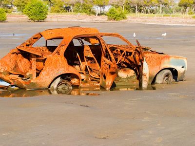 What should you use to clean rust from a car?