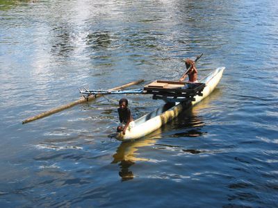 What is the purpose of outriggers on a kayak?