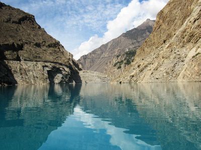 Which landform is a body of water surrounded by land on three sides?