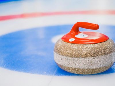 What material is the running surface of a curling stone made of?