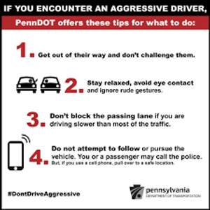 What should you NOT do if an aggressive driver confronts you at a stop?