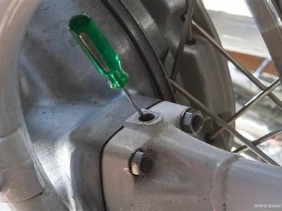 What should be done before checking the oil level in a truck?