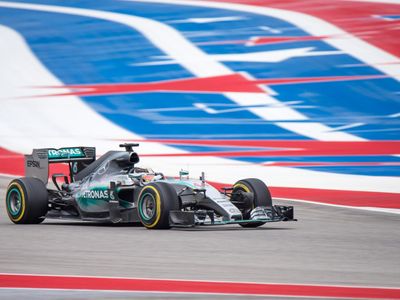 Which driver celebrated his win by performing donuts on the track?