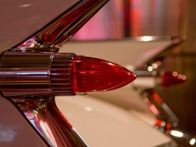 What classic car is known for its distinctive fins and rocket-inspired tail lights?