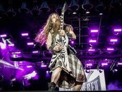 Which rock band's frontman is known for wearing a kilt while performing?