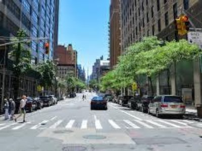 What should you do first when approaching a pedestrian crossing in a city?