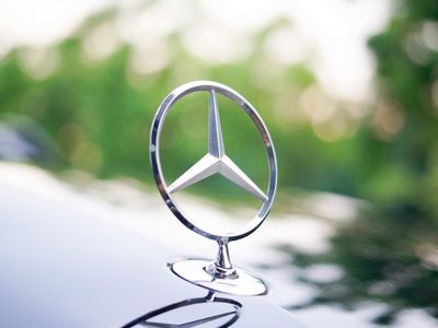 Which luxury car brand is known for its iconic three-pointed star logo?