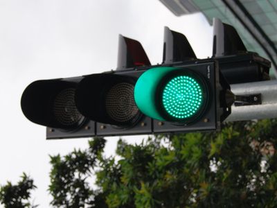 What does a steady green traffic light indicate?