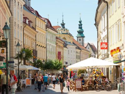 Which city is the educational and political center of Slovenian national minority in Austria?