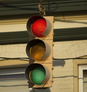 What should you do if you encounter a yellow traffic light at an intersection?