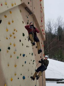 Which piece of equipment is used to secure the rope to the climber's harness?