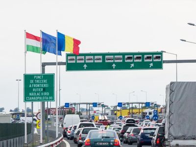 What does a blue sign with a white 'H' indicate on the highway?