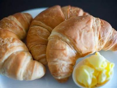 What type of cuisine is associated with croissants and escargot?