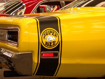 Which muscle car featured a Super Bee logo?