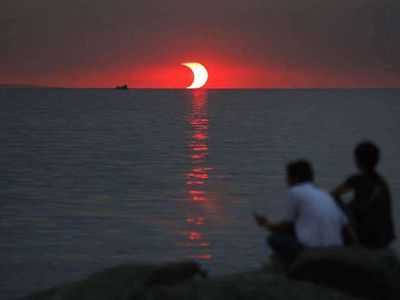 An eclipse and sunset happening at the same time