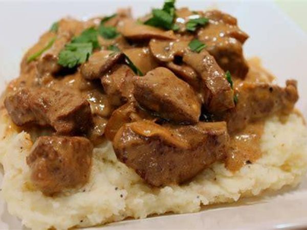 Beef Stroganoff?  “Beef stroganoff consists of strips of beef in a creamy sauce with mushrooms or tomatoes, often served with rice, noodles, or potatoes. This recipe has a long history, and many variations for its preparation exist.”